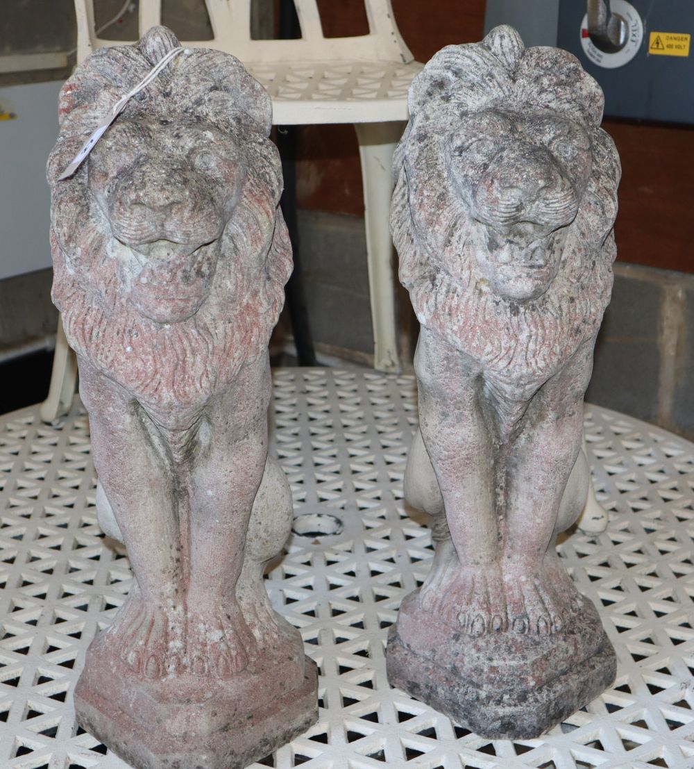 A pair of reconstituted stone lion garden ornaments, H.54cm